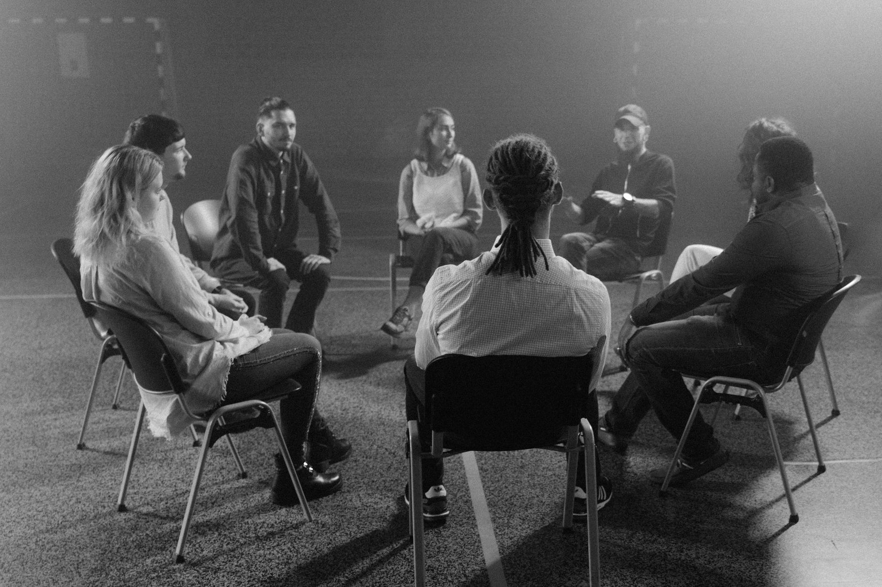 Diverse group of people sitting in a circle, sharing and supporting each other in a peer support session